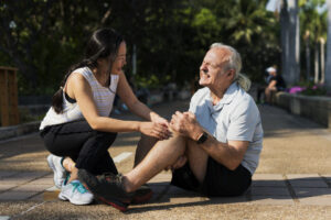 elderly man holding knee