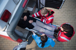 medics putting man in ambulance|medics transporting patient