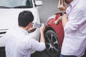 man taking picture of accident